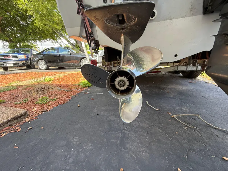Slide: The Image of Propeller of a 2005 Boston Whaler 260 Outrage boat on a trailer, parked outdoors. - 10