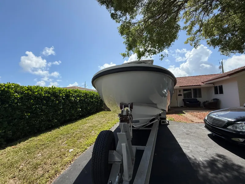 Slide: The Image of 2005 Boston Whaler 260 Outrage boat on trailer in driveway, sunny day. - 15