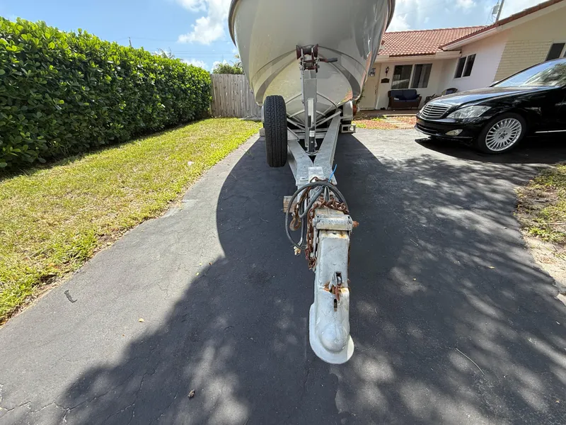 Slide: The Image of 2005 Boston Whaler 260 Outrage boat on trailer in driveway, sunny day. - 16