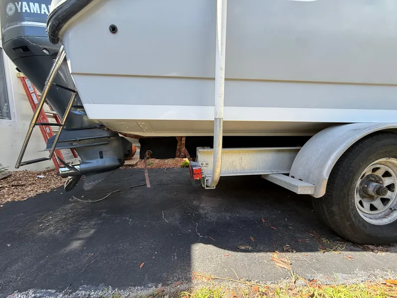 Slide: The Image of 2005 Boston Whaler 260 Outrage on trailer, featuring Yamaha outboard motor. - 21