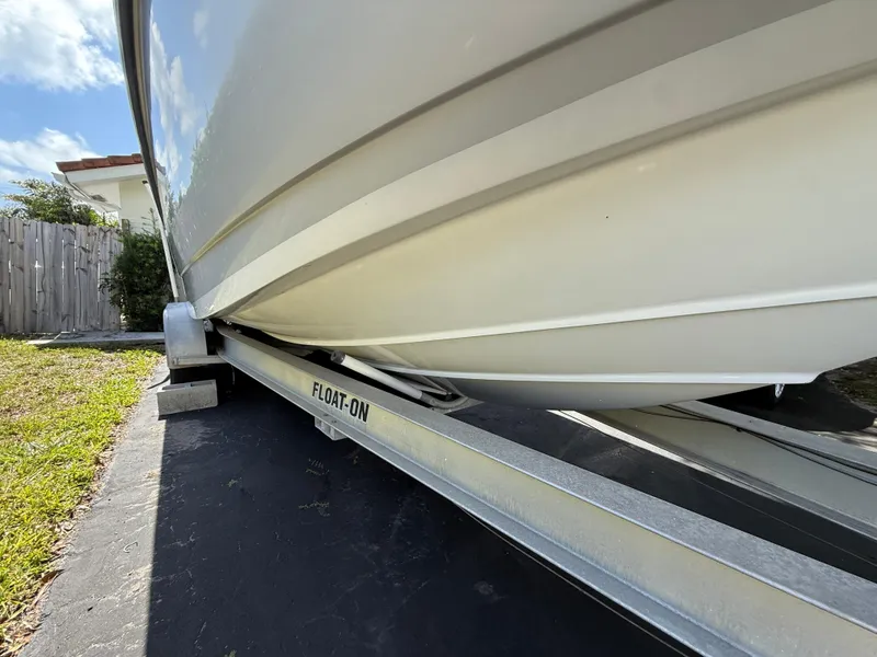 Slide: The Image of 2005 Boston Whaler 260 Outrage on a Float-On trailer, parked outdoors. - 23