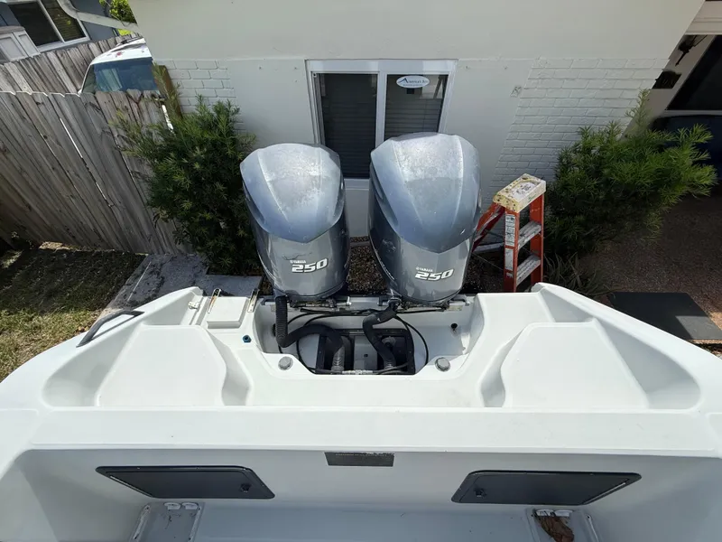 Slide: The Image of 2005 Boston Whaler 260 Outrage with twin Yamaha 250 engines, docked near a house. - 29