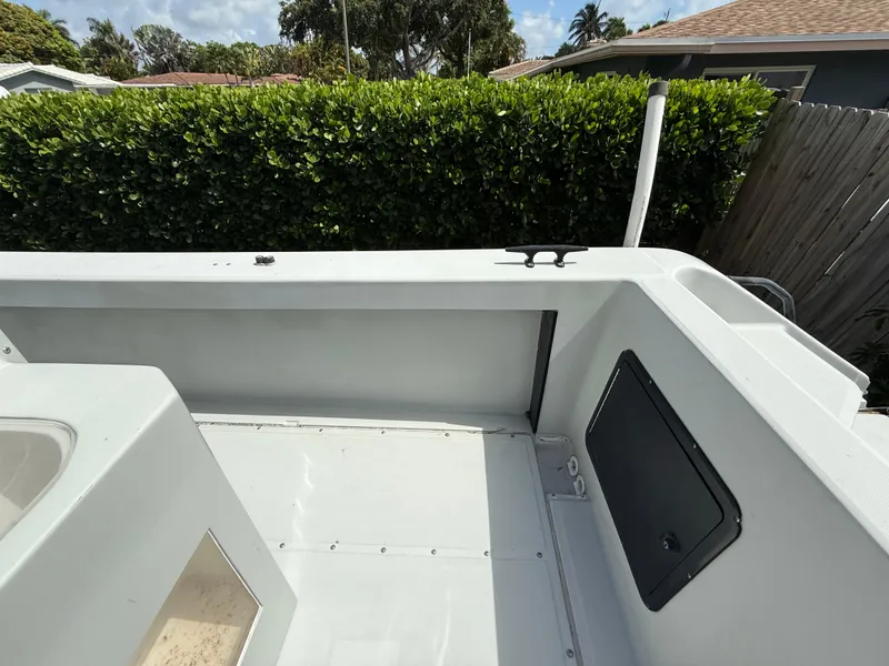 Slide: The Image of 2005 Boston Whaler 260 Outrage boat interior with clean deck and storage compartment. - 33