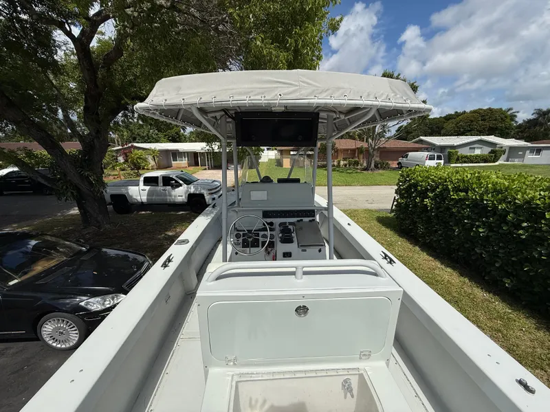 Slide: The Image of 2005 Boston Whaler 260 Outrage boat with canopy, parked in residential area. - 39