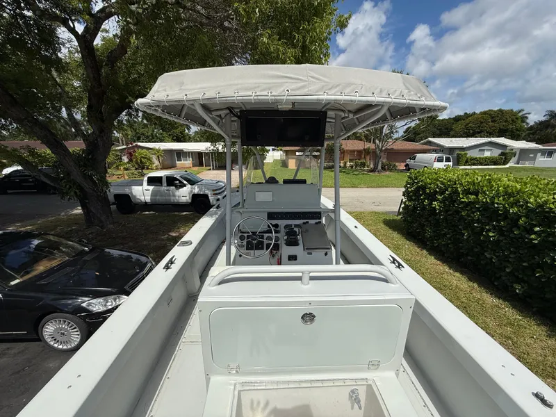 Slide: The Image of 2005 Boston Whaler 260 Outrage boat with canopy, parked in a residential area. - 40