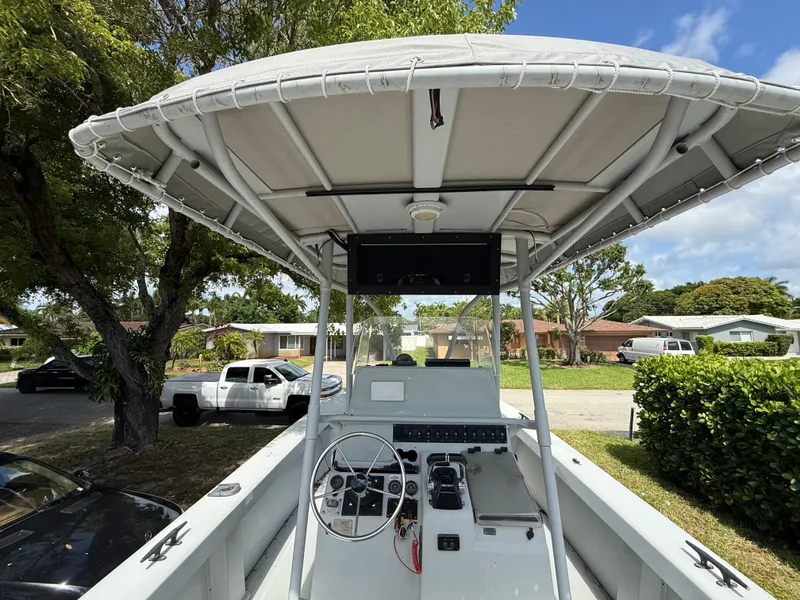 Slide: The Image of 2005 Boston Whaler 260 Outrage boat with canopy, parked in a residential area. - 42