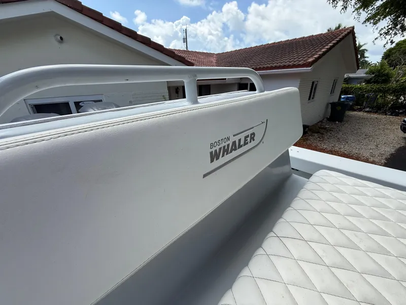 Slide: The Image of 2005 Boston Whaler 260 Outrage boat seat with logo, outdoor setting. - 46