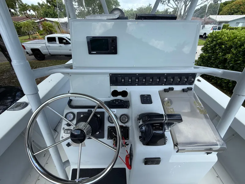 Slide: The Image of 2005 Boston Whaler 260 Outrage boat console with steering wheel and controls. - 48