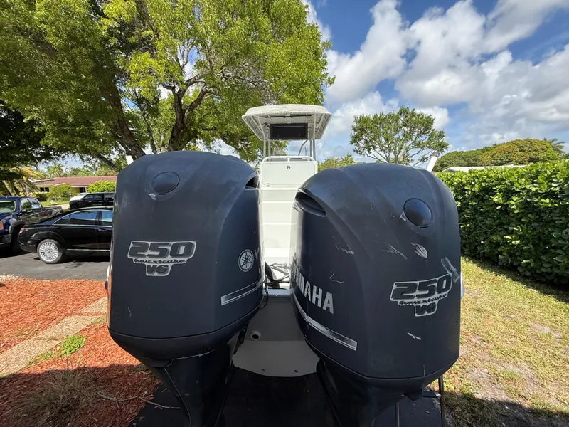 Slide: The Image of 2005 Boston Whaler 260 Outrage with twin Yamaha 250 engines, parked outdoors. - 8