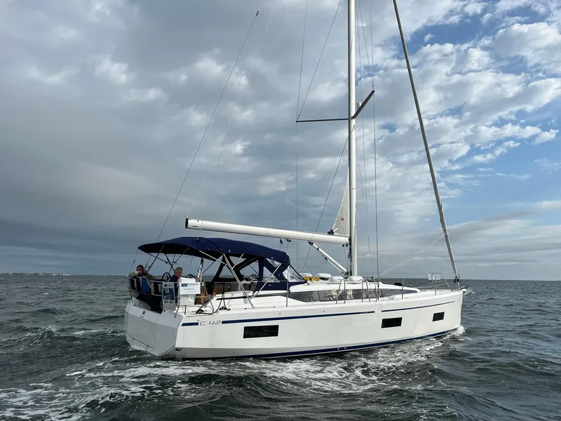 The Image of 2023 Bavaria C42 sailboat cruising on open water under a cloudy sky. - 0