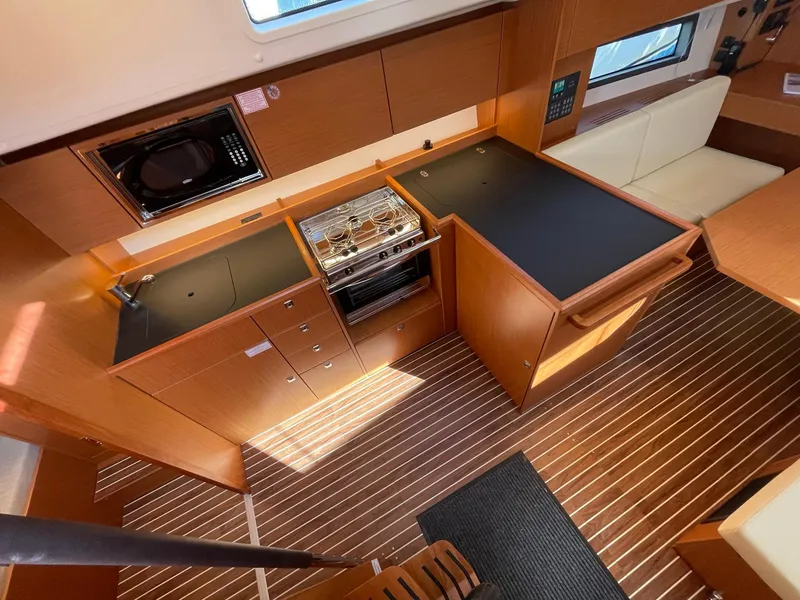 Slide: The Image of Modern kitchen interior of 2023 Bavaria C42 yacht with sleek wood finish and appliances. - 12