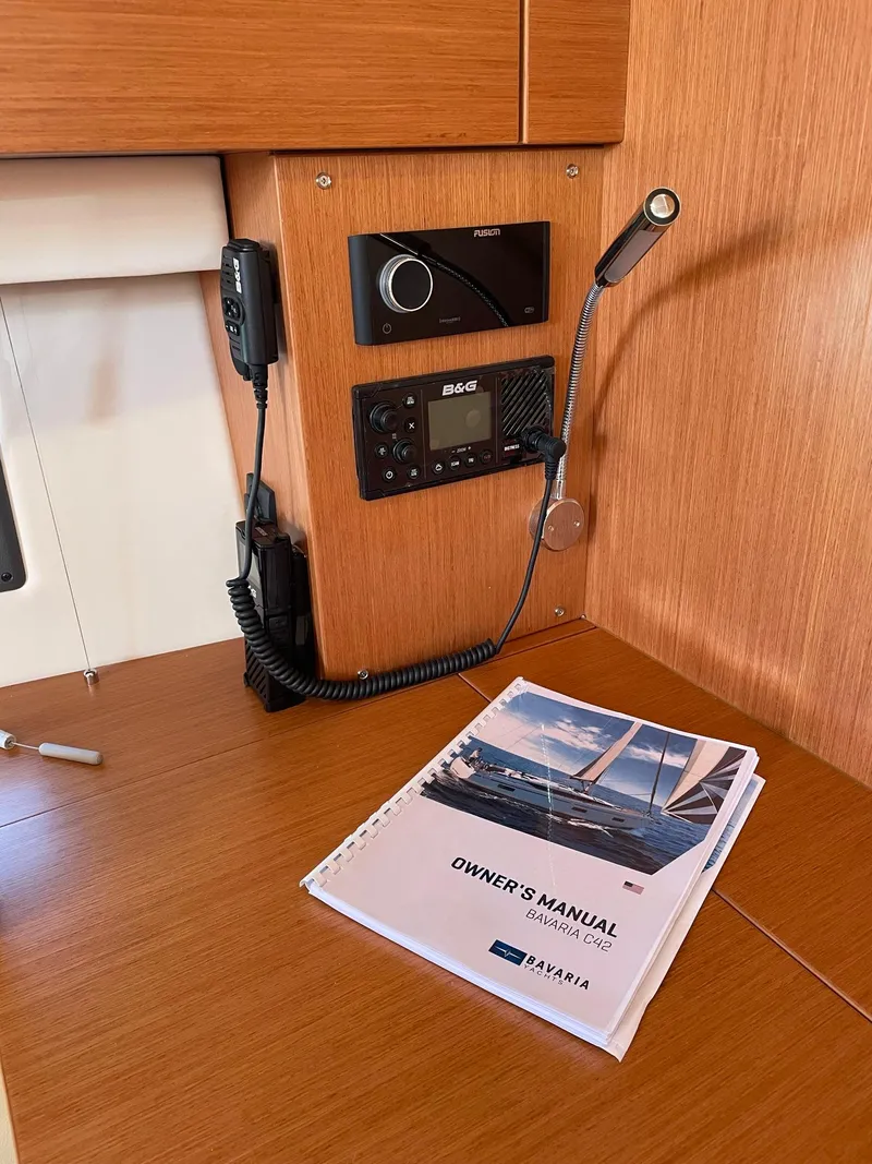 Slide: The Image of Owner's manual on Bavaria C42 yacht interior, 2023 model, with communication equipment. - 13