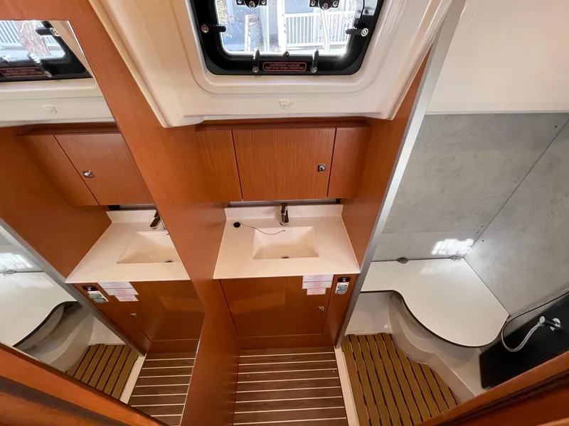 Slide: The Image of Modern bathroom interior of 2023 Bavaria C42 yacht, featuring wood accents and sleek fixtures. - 17