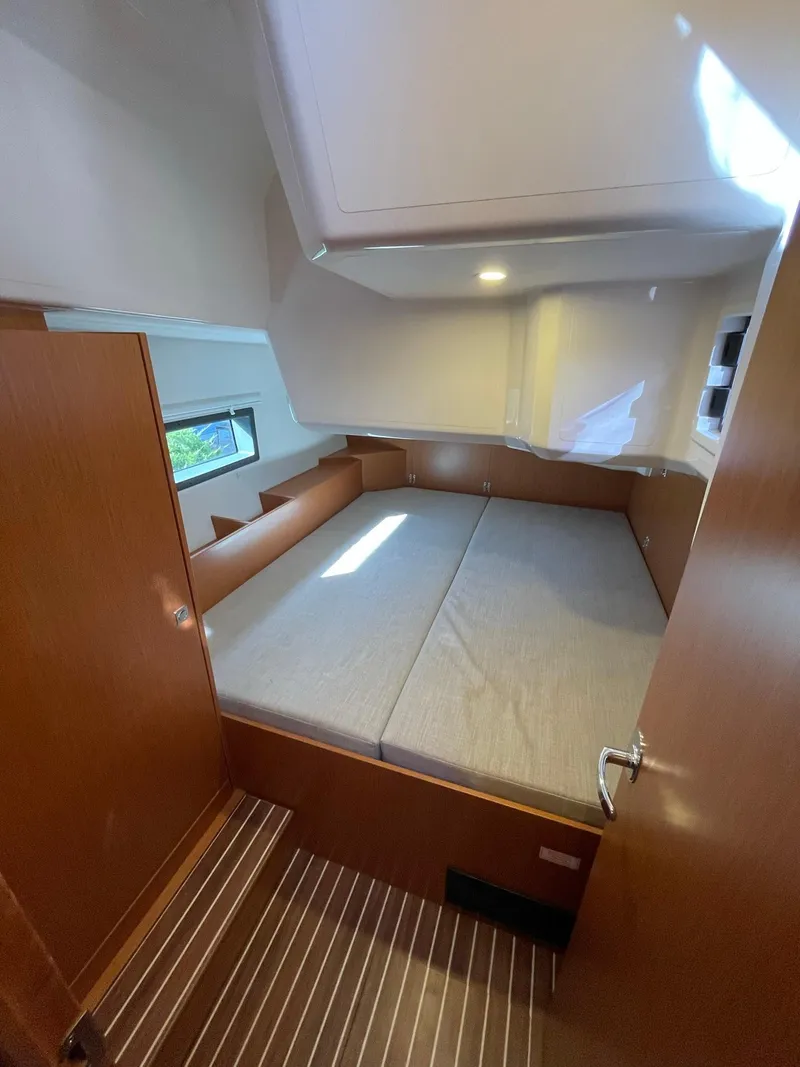 Slide: The Image of 2023 Bavaria C42 yacht cabin with double bed and wooden interior. - 19