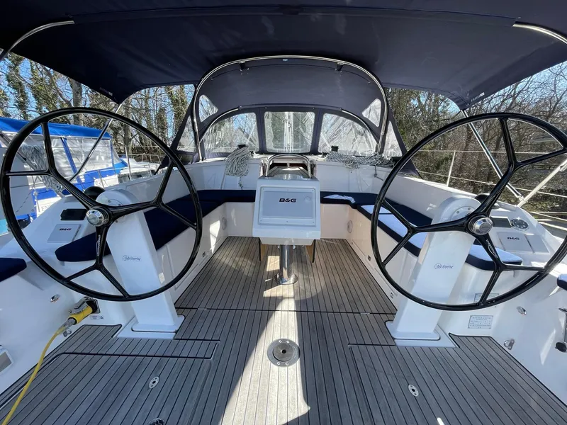 Slide: The Image of 2023 Bavaria C42 yacht cockpit with dual steering wheels and modern navigation equipment. - 2