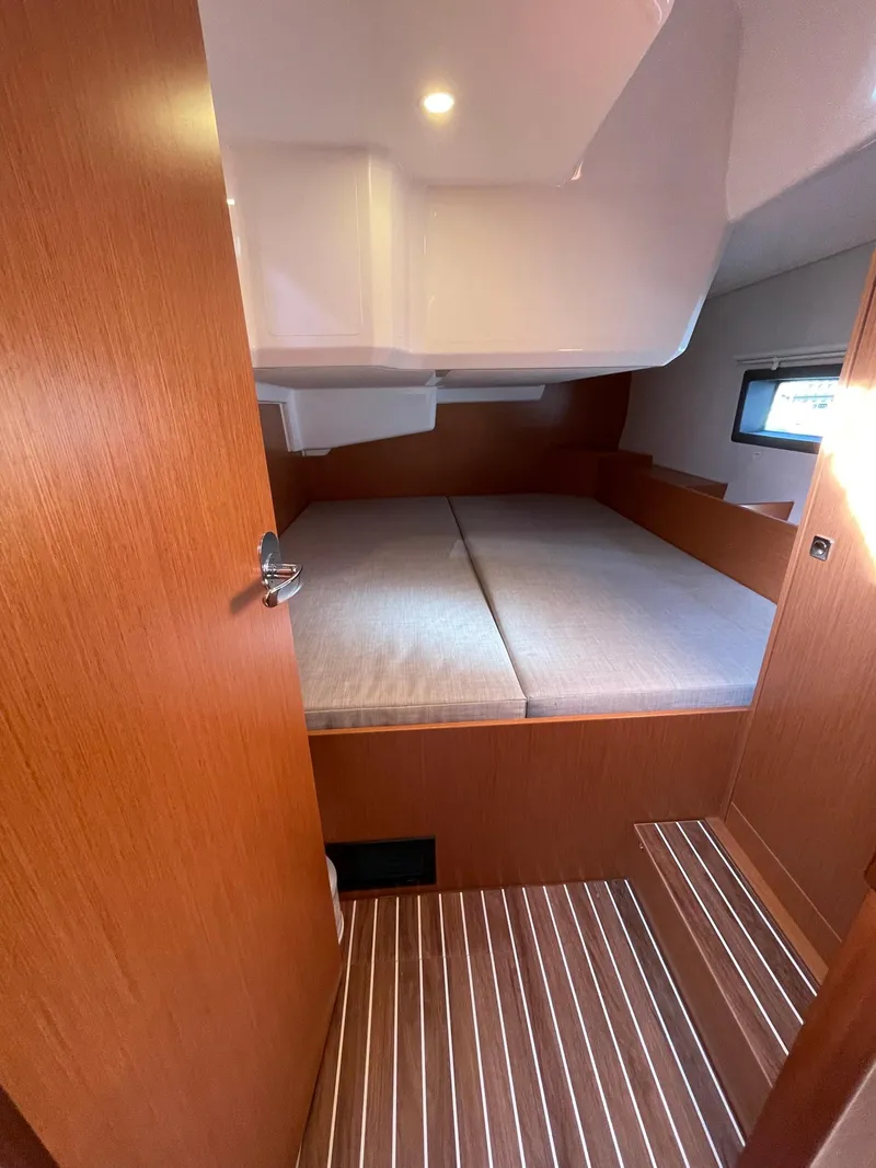 Slide: The Image of 2023 Bavaria C42 yacht cabin with wooden interior and cozy bed. - 20