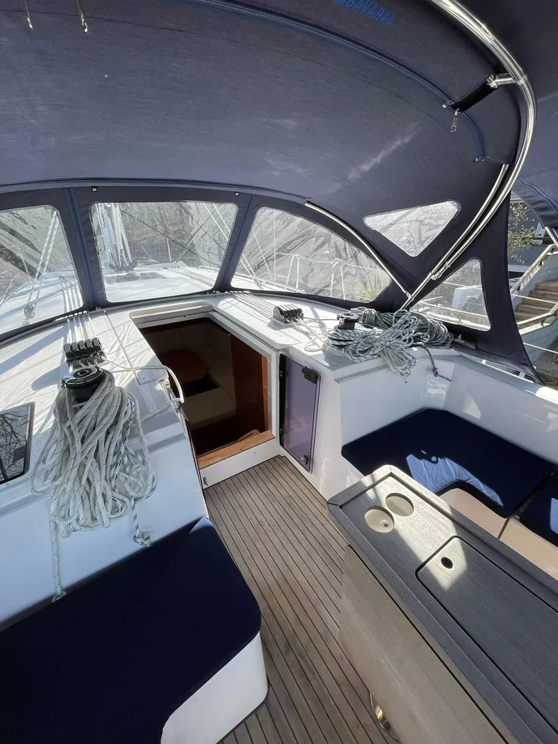 Slide: The Image of 2023 Bavaria C42 yacht cockpit with ropes, seating, and canopy. - 3
