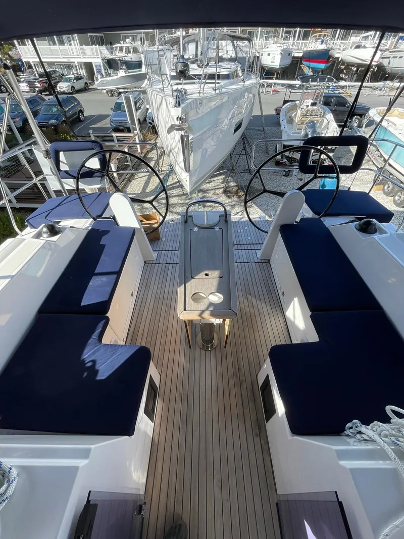 Slide: The Image of 2023 Bavaria C42 yacht cockpit with dual steering wheels and navy seating. - 4