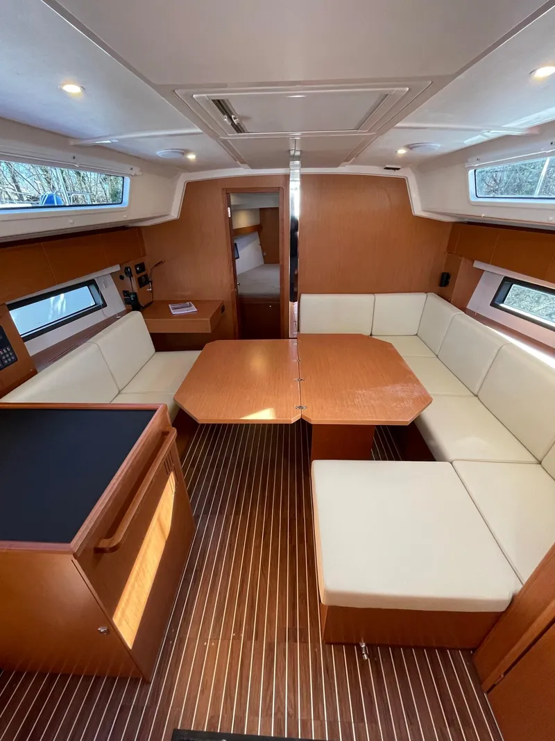 Slide: The Image of 2023 Bavaria C42 yacht interior with modern seating and wooden finishes. - 7