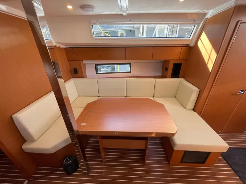Slide: The Image of Interior of 2023 Bavaria C42 yacht with wooden table and cream seating. - 8
