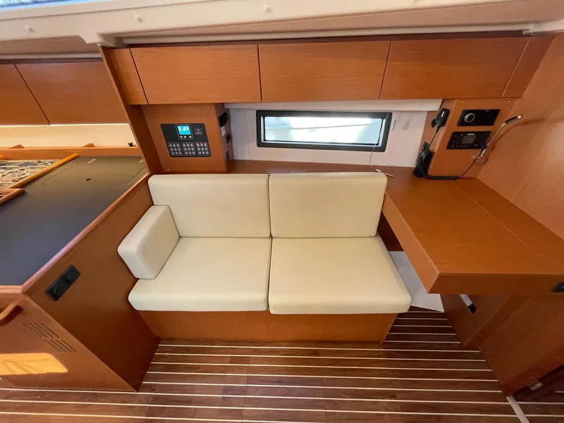 Slide: The Image of Interior of 2023 Bavaria C42 yacht with beige seating and wooden cabinetry. - 9