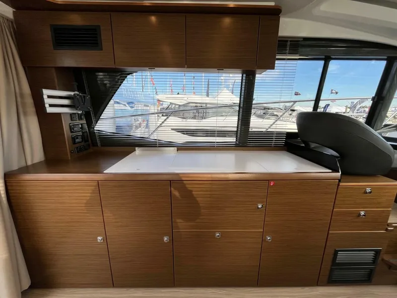 Slide: The Image of Interior of 2023 Bavaria R40 Coupe yacht with wooden cabinetry and large windows. - 6