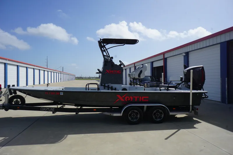 Slide: The Image of 2015 El Pescador 24 CAT boat on trailer, parked near storage units. - 4