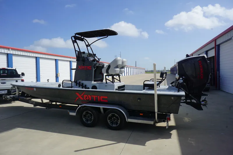 Slide: The Image of 2015 El Pescador 24 CAT boat on trailer, parked outside storage units. - 5