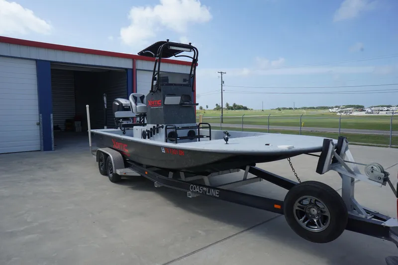 Slide: The Image of 2015 El Pescador 24 CAT boat on trailer outside storage facility. - 6