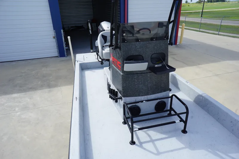 Slide: The Image of 2015 El Pescador 24 CAT boat with console, parked near storage facility. - 9