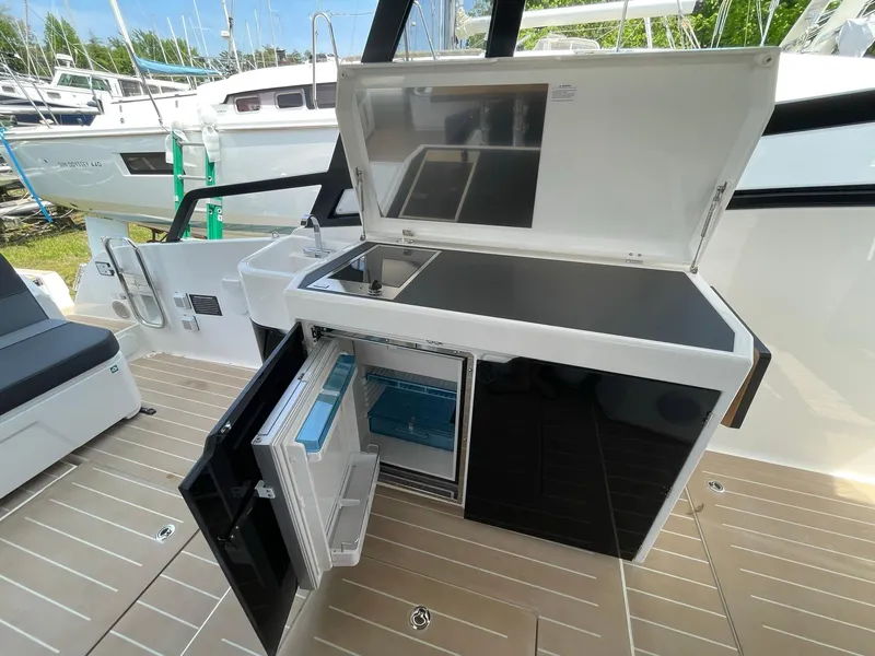 Slide: The Image of Outdoor kitchen on 2023 Bavaria Vida 33 yacht with open fridge and storage. - 11