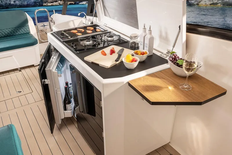 Slide: The Image of Modern kitchen on Bavaria Vida 33 yacht, featuring stove, fridge, and elegant dining setup. - 12