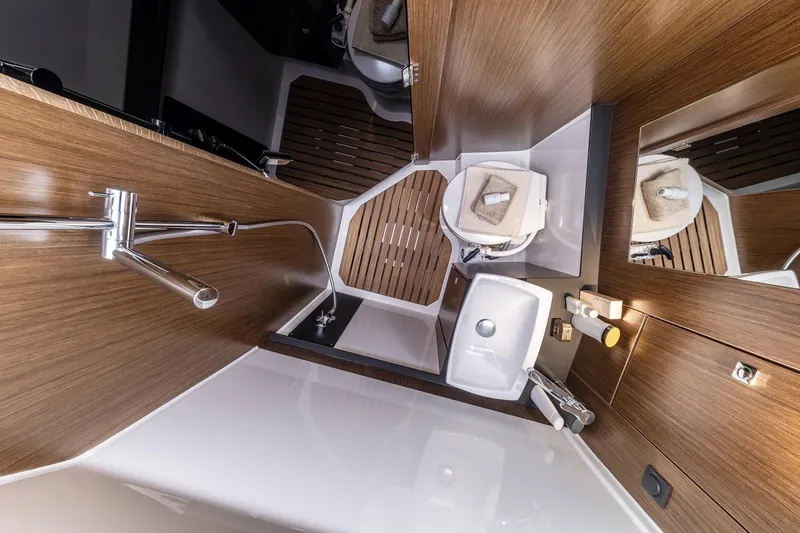 Slide: The Image of Modern bathroom interior of 2023 Bavaria Vida 33 yacht, featuring wood accents and sleek fixtures. - 17