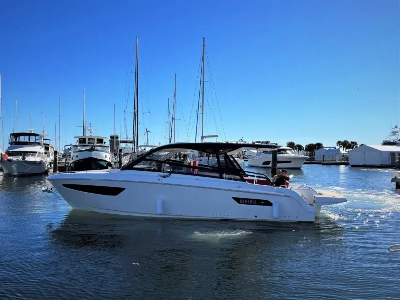 Slide: The Image of 2023 Bavaria Vida 33 yacht cruising in a marina under clear blue skies. - 19