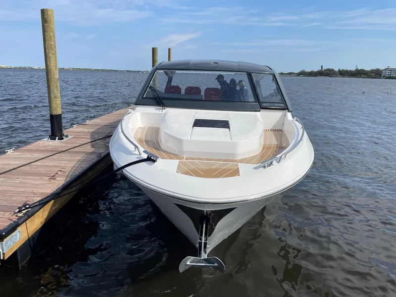 Slide: The Image of 2023 Bavaria Vida 33 boat docked on calm water under a clear sky. - 3