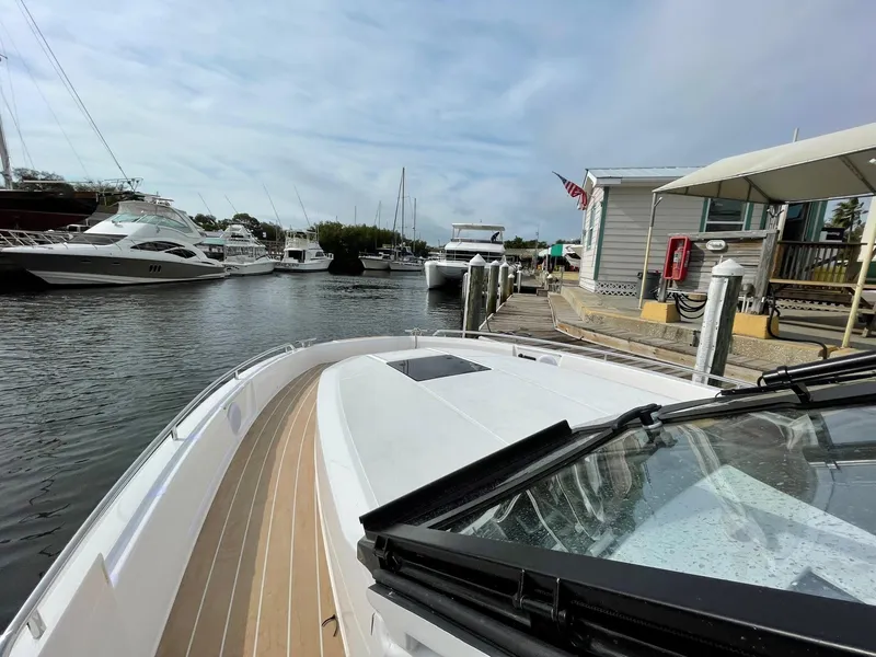 Slide: The Image of Bavaria Vida 33 boat docked at marina, surrounded by other yachts, 2023 model. - 6