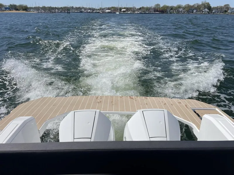 Slide: The Image of 2023 Bavaria Vida 33 boat cruising on open water, leaving a wake behind. - 8