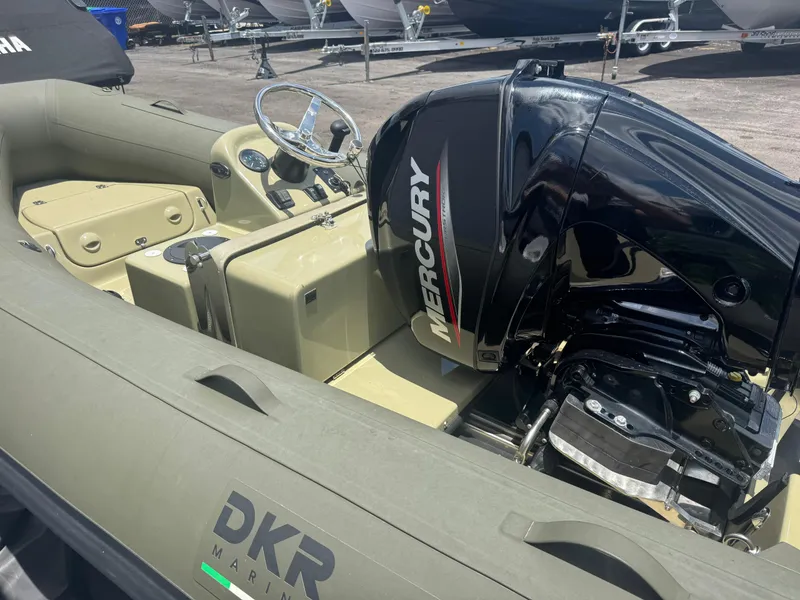 Slide: The Image of 2022 Geniuss 380 HTS boat with Mercury engine, beige interior, and DKR Marine branding. - 10