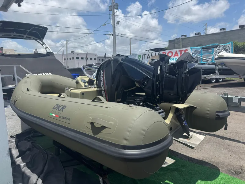 Slide: The Image of 2022 Geniuss 380 HTS inflatable boat with Mercury engine, displayed outdoors. - 11