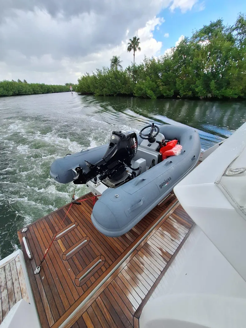 Slide: The Image of Inflatable boat Geniuss 380 HTS 2022 on yacht deck, surrounded by lush greenery. - 20
