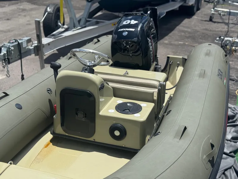 Slide: The Image of 2022 Geniuss 380 HTS inflatable boat with Mercury 40 outboard motor, parked on a trailer. - 3