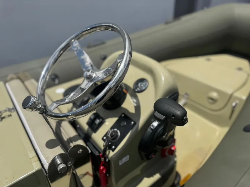 Slide: The Image of Steering wheel and controls of a 2022 Geniuss 380 HTS boat. - 7