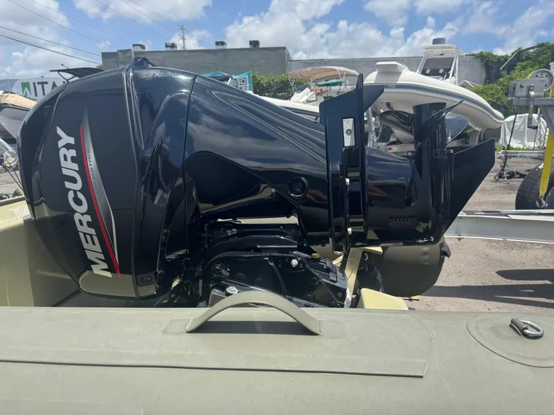 Slide: The Image of Outboard Mercury engine on a 2022 Geniuss 380 HTS boat, parked outdoors. - 9