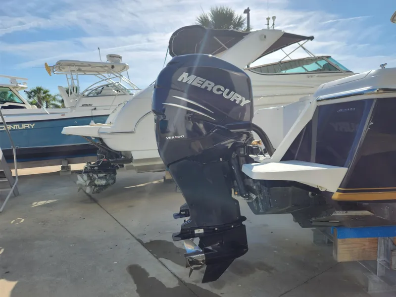 Slide: The Image of 2008 Intrepid 323 Cuddy with Mercury Verado outboard engine, docked alongside other boats. - 10