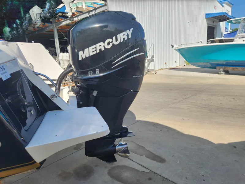 Slide: The Image of 2008 Intrepid 323 Cuddy with Mercury Verado outboard motor in a marina setting. - 11