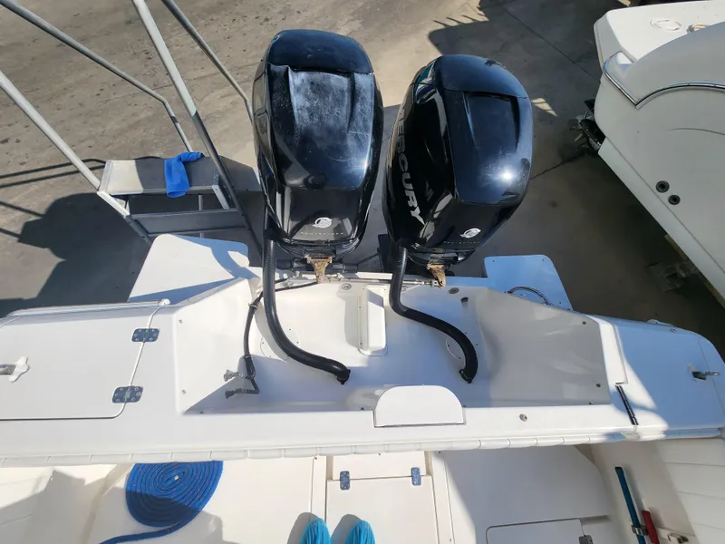 Slide: The Image of 2008 Intrepid 323 Cuddy boat with dual Mercury outboard engines, docked and ready for use. - 13
