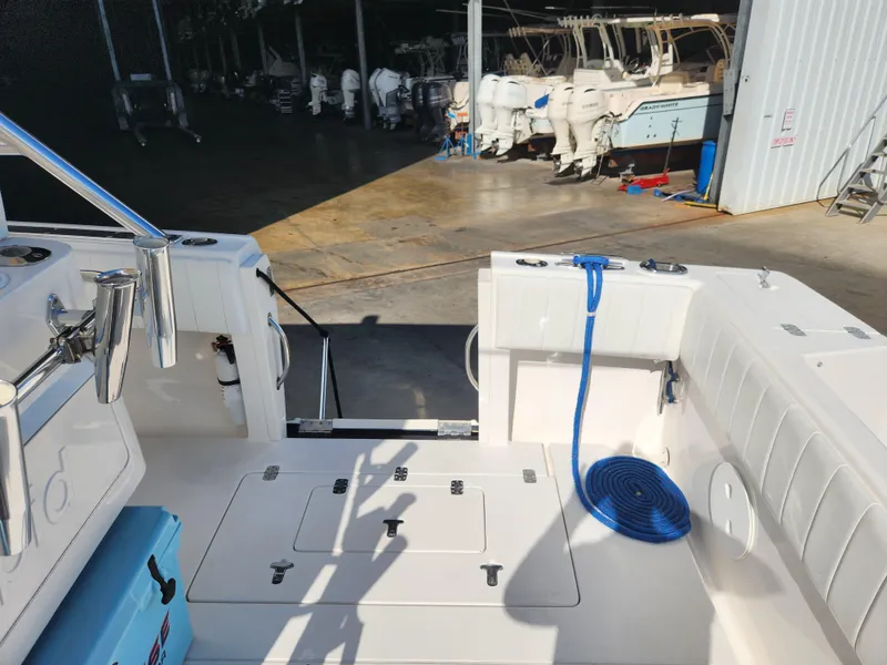 Slide: The Image of 2008 Intrepid 323 Cuddy boat interior with blue rope and storage compartments. - 16