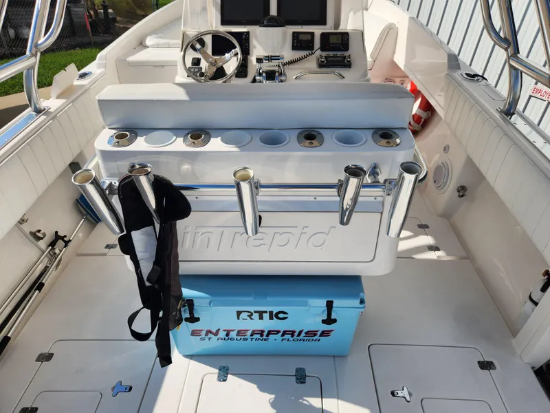 Slide: The Image of Interior of a 2008 Intrepid 323 Cuddy boat with fishing rod holders and RTIC cooler. - 18