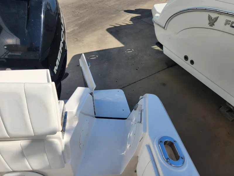 Slide: The Image of 2008 Intrepid 323 Cuddy boat with Mercury engine, featuring white seating and deck details. - 19