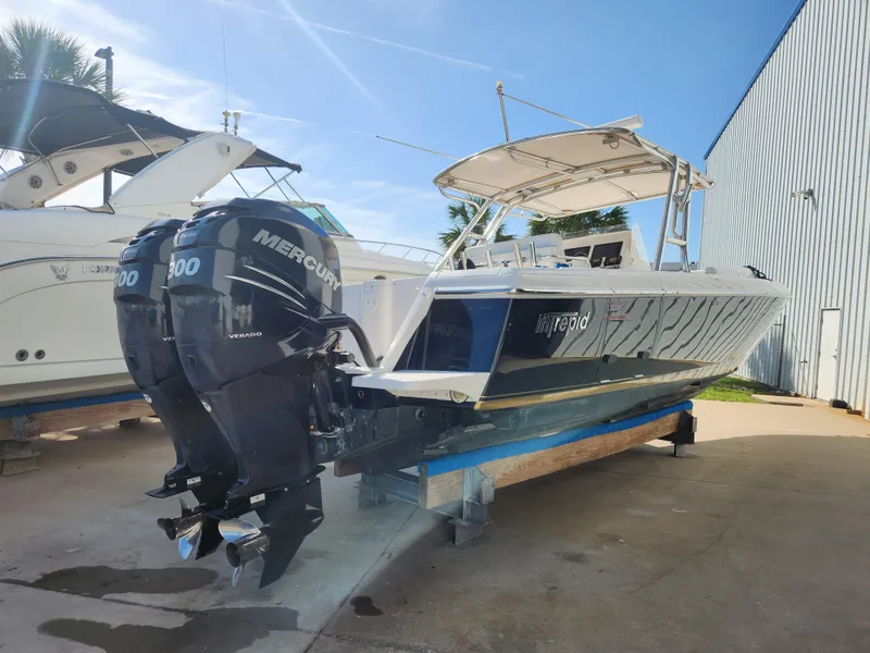 Slide: The Image of 2008 Intrepid 323 Cuddy boat with twin Mercury 300 engines on display. - 2